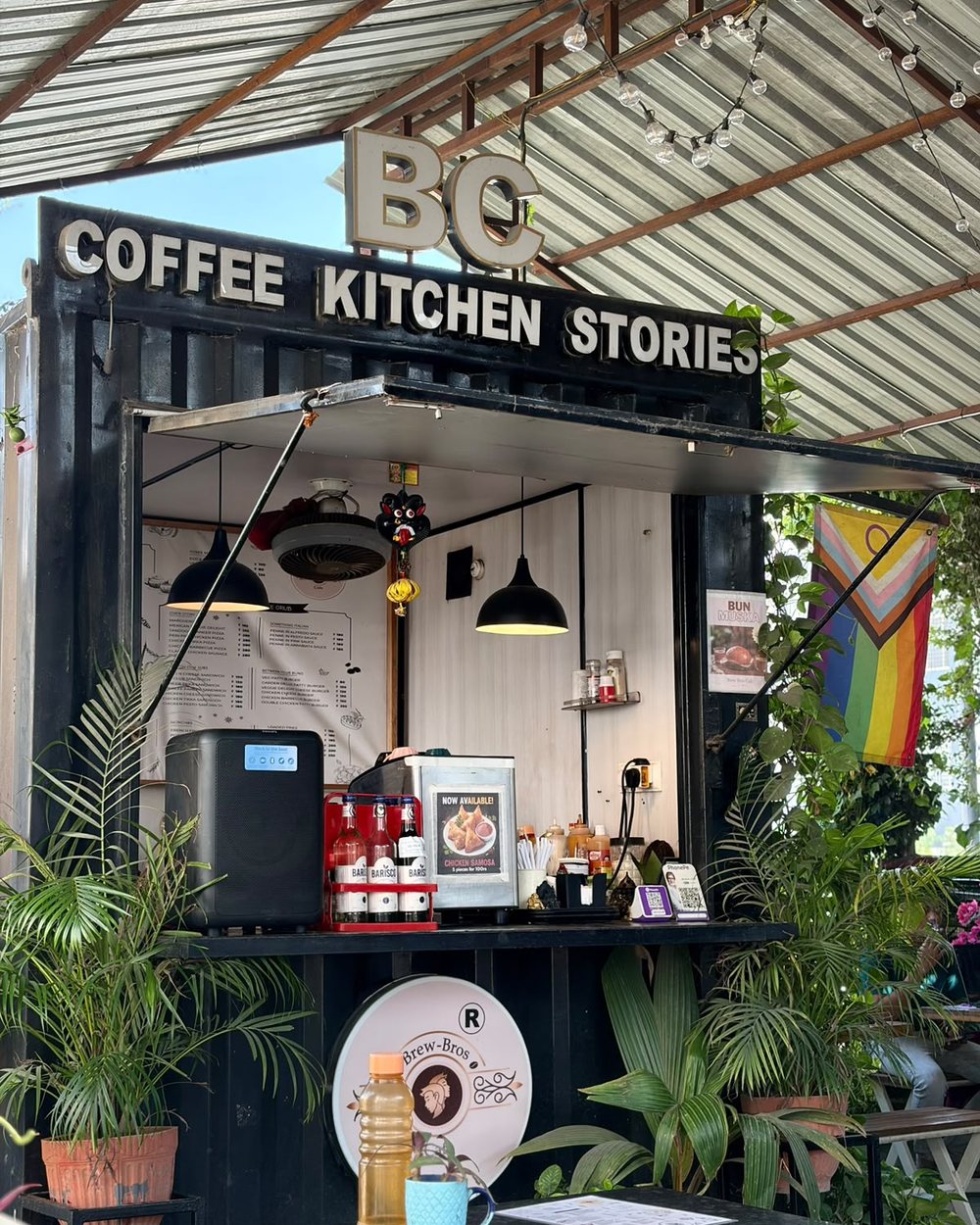 The Brew-Bros container counter by day, under the BC Coffee Kitchen Stories sign